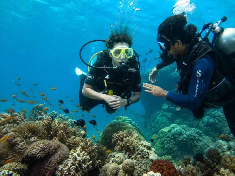 beginner scuba diver with instructor underwater — scuba diving cost in Goa, Atlantis Watersports